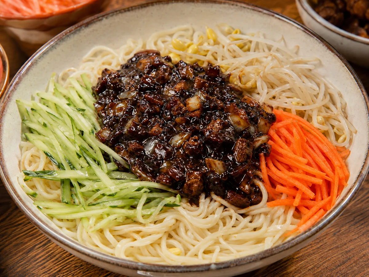 Beijing zhajiang noodles with rich fermented soybean sauce and neatly arranged fresh vegetable toppings